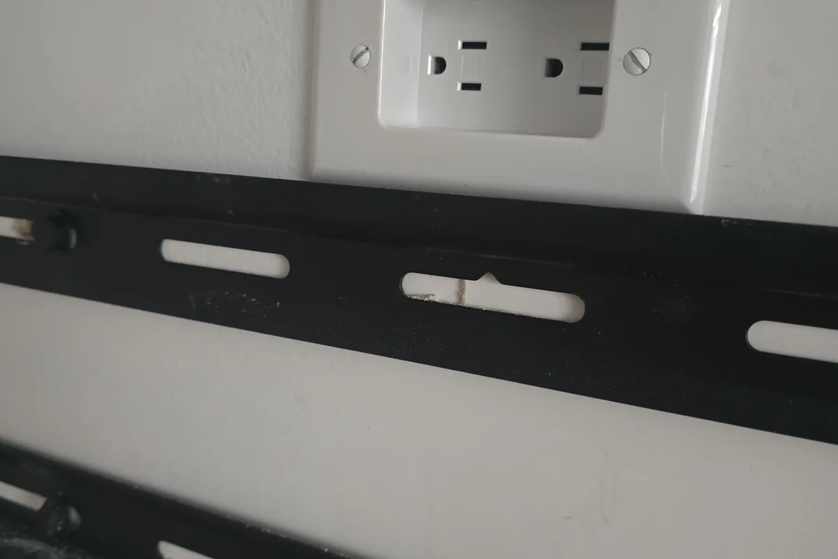 Electrical outlet installed above a TV mount for a wireless smart home experience